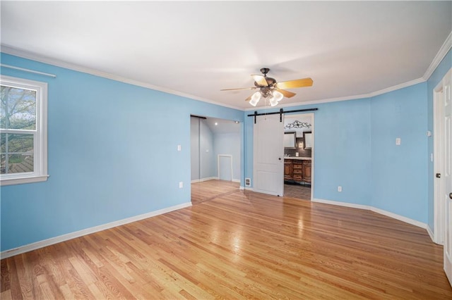 10100 El Monte St, Overland Park, KS 66207 - interior space featuring light wood-type flooring, a barn door, baseboards, and a ceiling fan