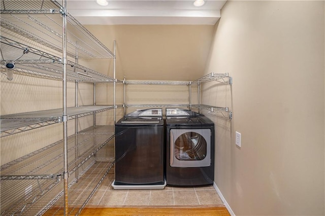 10100 El Monte St, Overland Park, KS 66207 - laundry area with washing machine and clothes dryer, laundry area, baseboards, and tile patterned floors