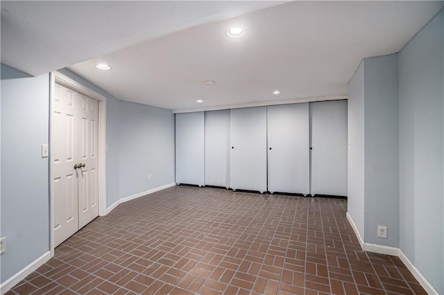 10100 El Monte St, Overland Park, KS 66207 - basement featuring baseboards, brick patterned floor, and recessed lighting