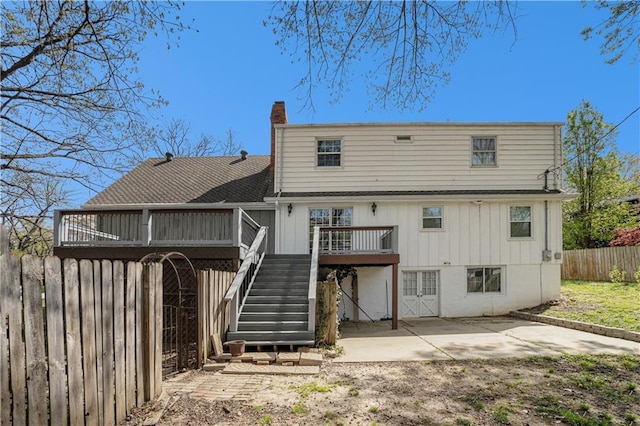 10100 El Monte St, Overland Park, KS 66207 - rear view of house with fence, stairs, a wooden deck, a chimney, and a patio