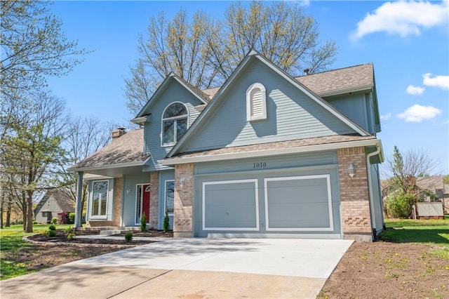1010 SW Cross Creek Dr, Grain Valley, MO 64029 - view of front facade with concrete driveway, an attached garage, brick siding, and a shingled roof