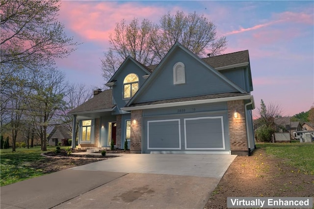 1010 SW Cross Creek Dr, Grain Valley, MO 64029 - view of front of home featuring brick siding, an attached garage, driveway, and a shingled roof