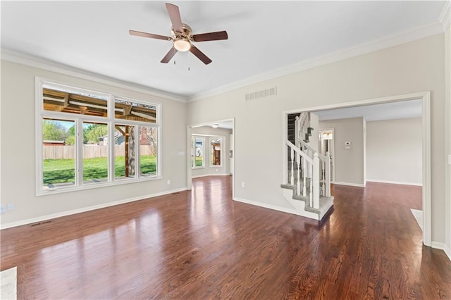 1010 SW Cross Creek Dr, Grain Valley, MO 64029 - unfurnished living room featuring dark wood-style flooring, visible vents, a ceiling fan, stairs, and crown molding