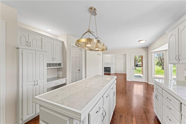 1010 SW Cross Creek Dr, Grain Valley, MO 64029 - kitchen featuring hanging light fixtures, white cabinetry, dark wood-style flooring, a kitchen island, and recessed lighting