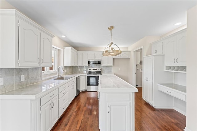 1010 SW Cross Creek Dr, Grain Valley, MO 64029 - kitchen with a sink, dark wood-type flooring, and appliances with stainless steel finishes