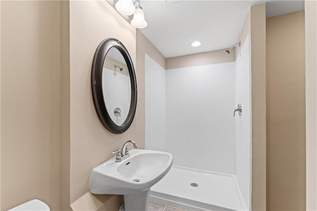 1010 SW Cross Creek Dr, Grain Valley, MO 64029 - bathroom featuring toilet, a shower, and a sink