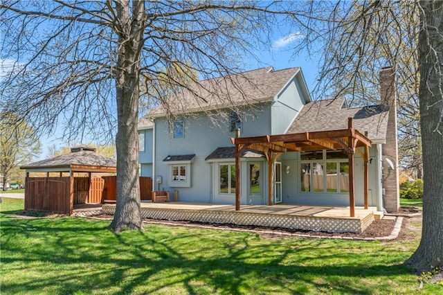 1010 SW Cross Creek Dr, Grain Valley, MO 64029 - rear view of property with a gazebo, a chimney, a shingled roof, a deck, and a yard