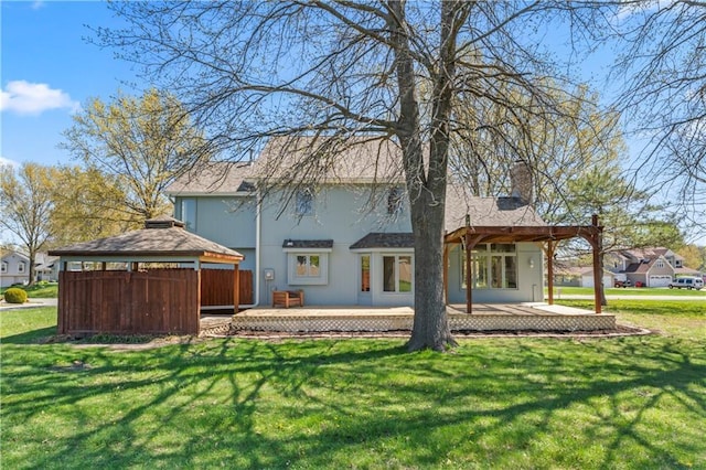 1010 SW Cross Creek Dr, Grain Valley, MO 64029 - back of property featuring a wooden deck, a lawn, and a gazebo