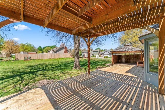 1010 SW Cross Creek Dr, Grain Valley, MO 64029 - wooden terrace with a gazebo, a lawn, and fence
