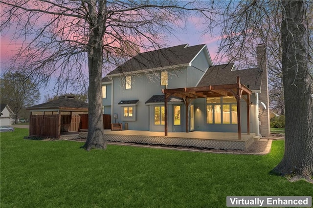 1010 SW Cross Creek Dr, Grain Valley, MO 64029 - back of property at dusk with a lawn, a wooden deck, and a chimney
