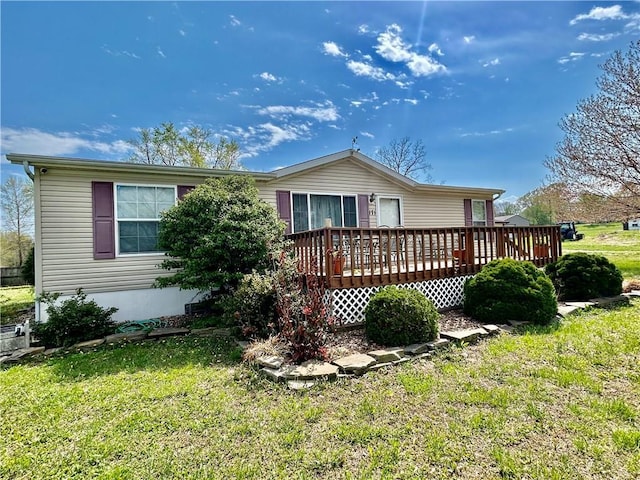 171 E 5th St, Schell City, MO 64783 - view of front of property with a wooden deck and a front lawn