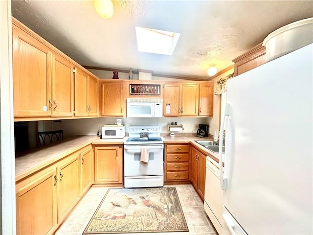 171 E 5th St, Schell City, MO 64783 - kitchen with light countertops, a skylight, light brown cabinets, and white appliances