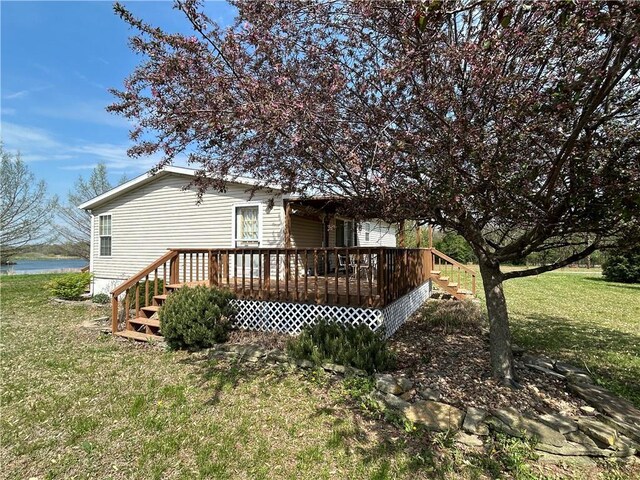 171 E 5th St, Schell City, MO 64783 - rear view of property featuring a deck with water view and a yard