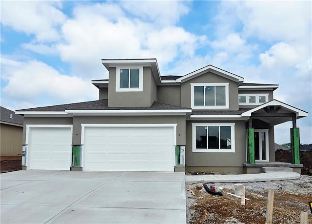 2615 SW Firefly Ln, Lees Summit, MO 64082 - prairie-style home featuring stucco siding, concrete driveway, a shingled roof, and a garage