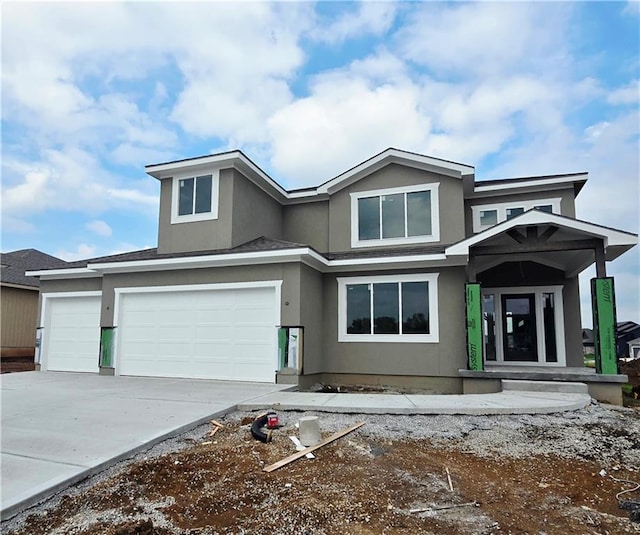 2615 SW Firefly Ln, Lees Summit, MO 64082 - view of front facade featuring stucco siding, driveway, and an attached garage