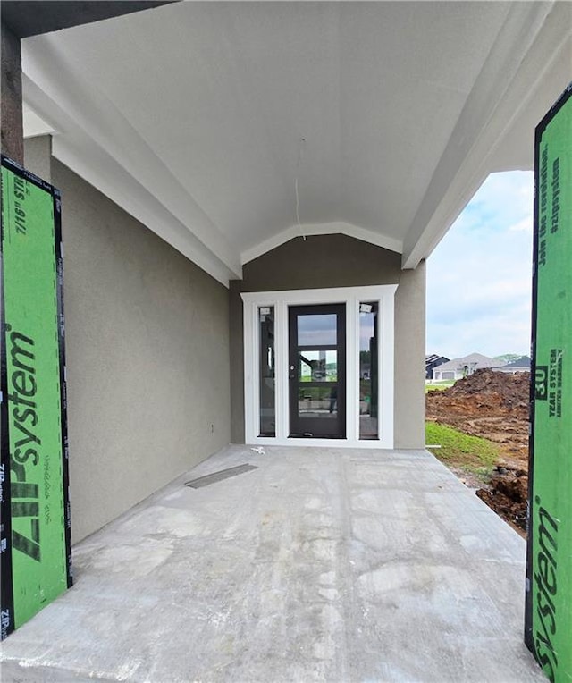 2615 SW Firefly Ln, Lees Summit, MO 64082 - entrance to property featuring a patio and stucco siding