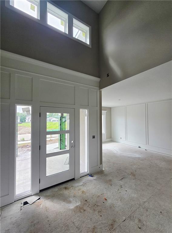 2615 SW Firefly Ln, Lees Summit, MO 64082 - unfurnished room featuring a decorative wall and a towering ceiling