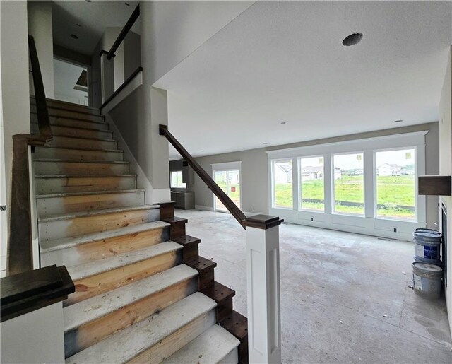 2615 SW Firefly Ln, Lees Summit, MO 64082 - staircase featuring unfinished concrete floors