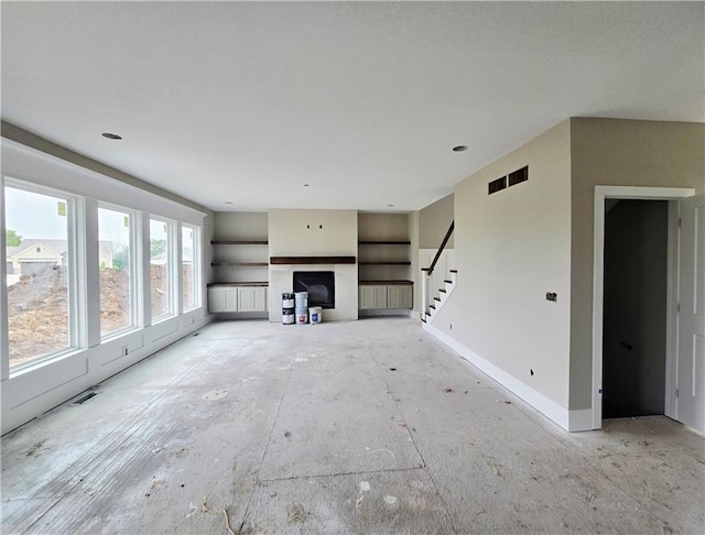 2615 SW Firefly Ln, Lees Summit, MO 64082 - unfurnished living room featuring stairs, a fireplace, and baseboards