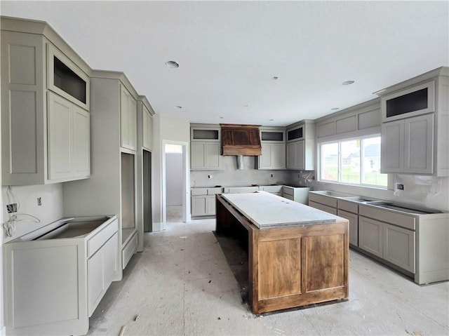 2615 SW Firefly Ln, Lees Summit, MO 64082 - kitchen with a center island, gray cabinetry, and glass insert cabinets