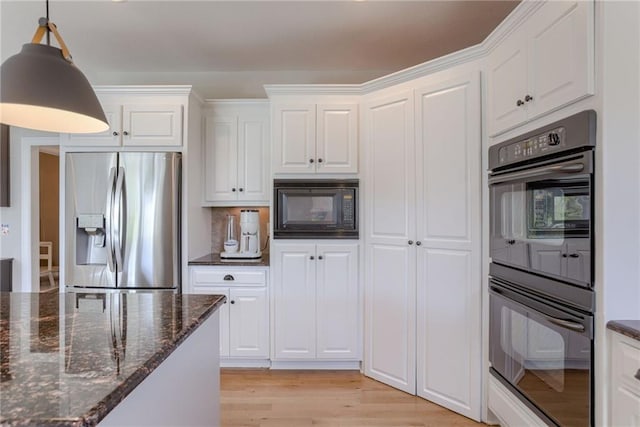 9500 N Lane Ave, Kansas City, MO 64157 - kitchen with white cabinets, decorative light fixtures, black appliances, and light wood-style floors
