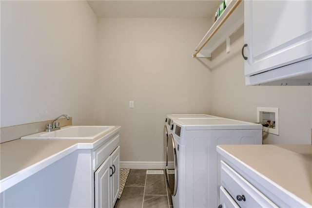 9500 N Lane Ave, Kansas City, MO 64157 - laundry room with cabinet space, a sink, separate washer and dryer, baseboards, and dark tile patterned flooring