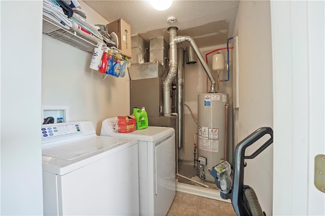 laundry area featuring laundry area, light tile patterned floors, gas water heater, washing machine and clothes dryer, and a textured ceiling