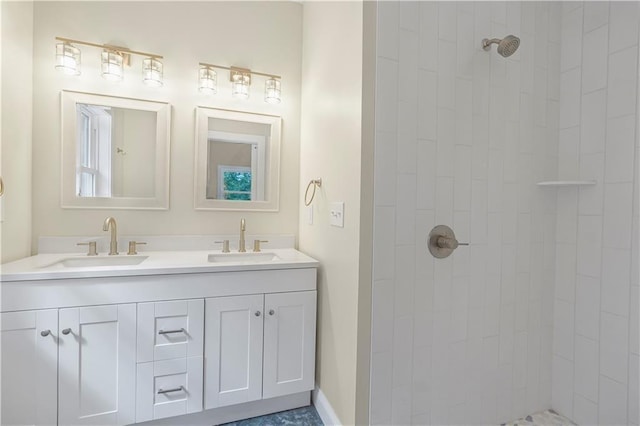 full bathroom featuring a sink, double vanity, and tiled shower