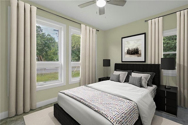 bedroom with baseboards and a ceiling fan