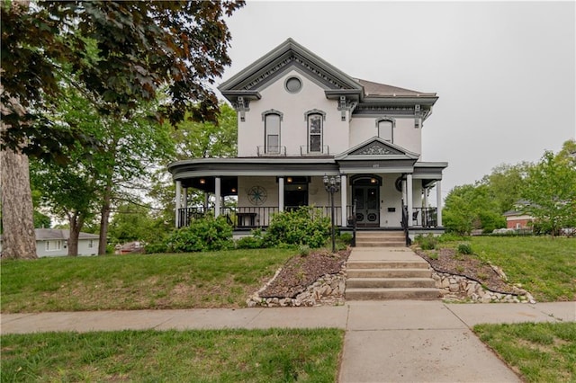 603 N 5th St, Atchison, KS 66002 - italianate house with a porch, a front yard, and stucco siding