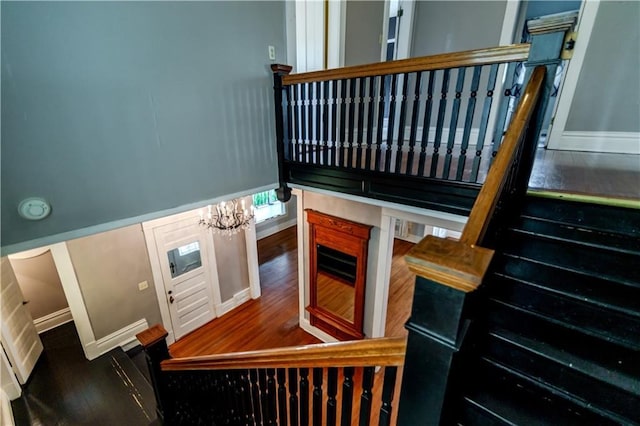 603 N 5th St, Atchison, KS 66002 - staircase with a chandelier and baseboards