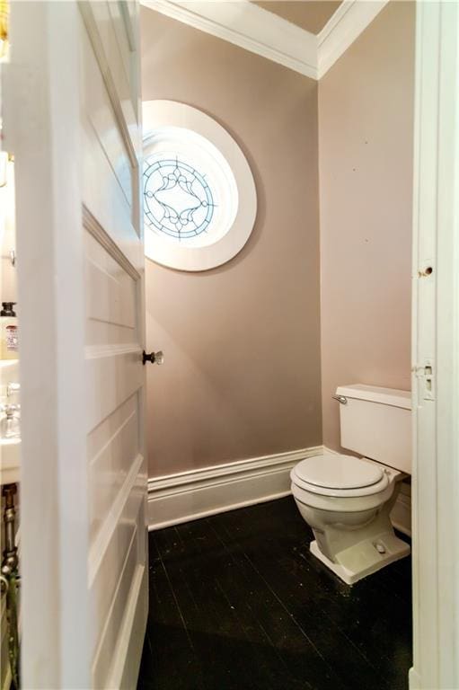 603 N 5th St, Atchison, KS 66002 - bathroom featuring crown molding, toilet, and baseboards