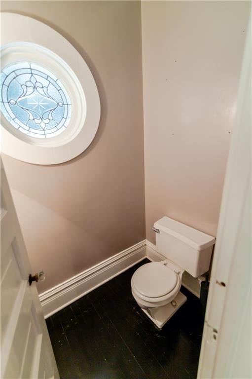 603 N 5th St, Atchison, KS 66002 - bathroom featuring toilet, wood finished floors, and baseboards