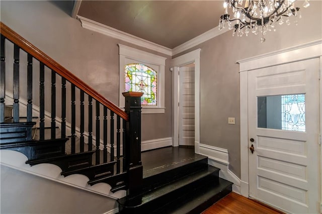 603 N 5th St, Atchison, KS 66002 - entrance foyer featuring stairs, a chandelier, crown molding, and wood finished floors