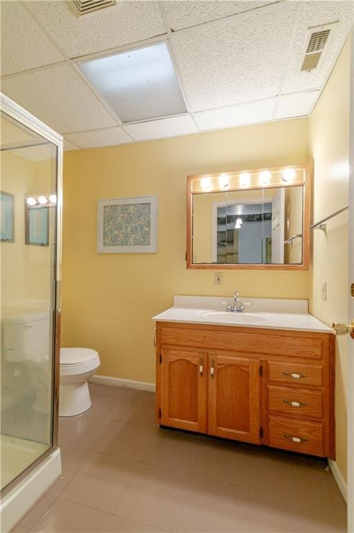 603 N 5th St, Atchison, KS 66002 - bathroom featuring a paneled ceiling, vanity, toilet, a stall shower, and tile patterned floors