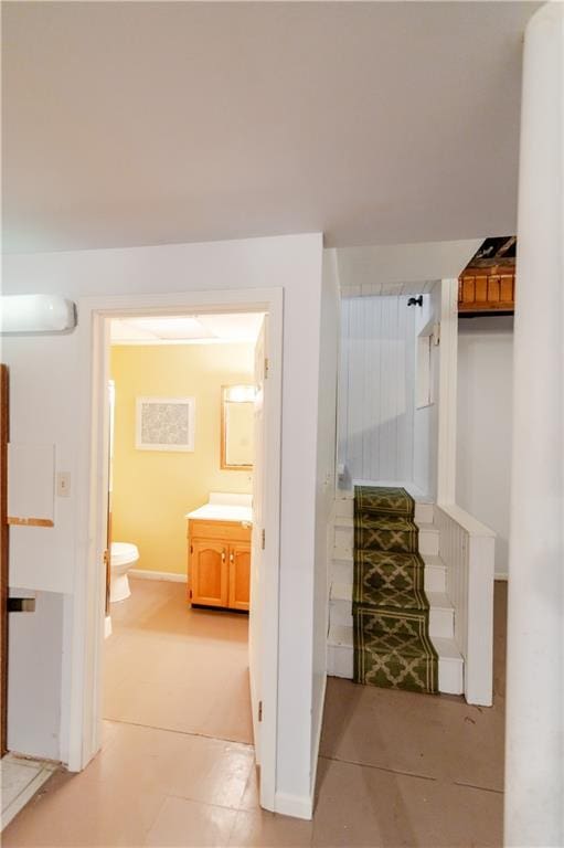 603 N 5th St, Atchison, KS 66002 - hallway featuring baseboards, light tile patterned floors, and stairway