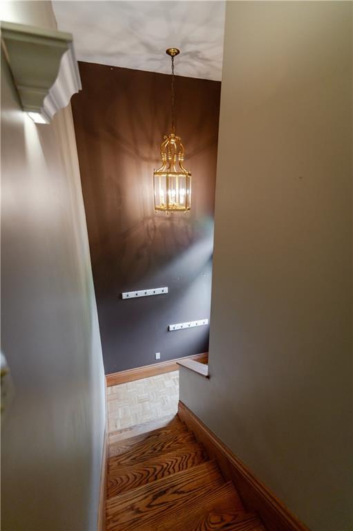 603 N 5th St, Atchison, KS 66002 - staircase with baseboards and a chandelier