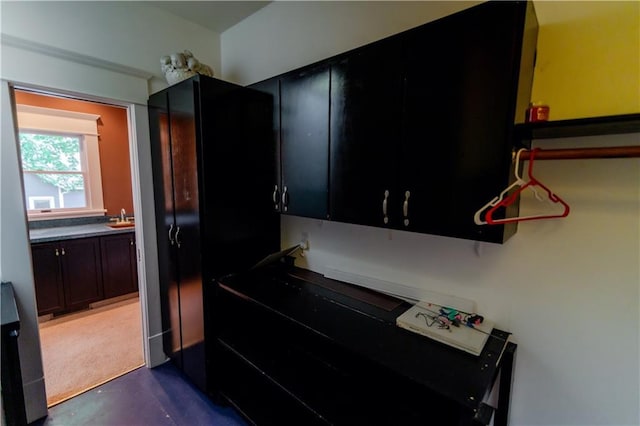 603 N 5th St, Atchison, KS 66002 - kitchen featuring dark cabinetry, a sink, and concrete floors