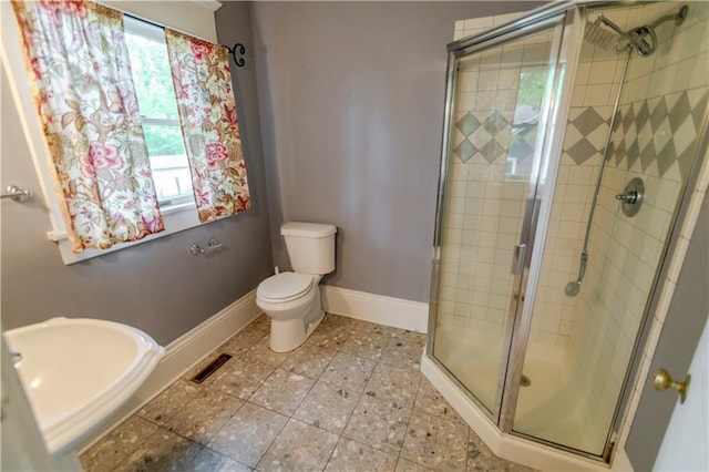 603 N 5th St, Atchison, KS 66002 - bathroom with toilet, a stall shower, baseboards, and tile patterned floors