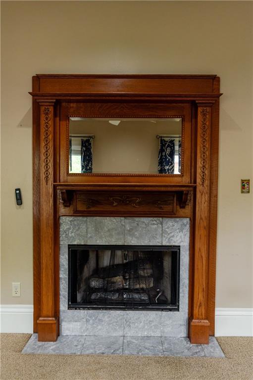 603 N 5th St, Atchison, KS 66002 - detailed view of a tiled fireplace, carpet, and baseboards