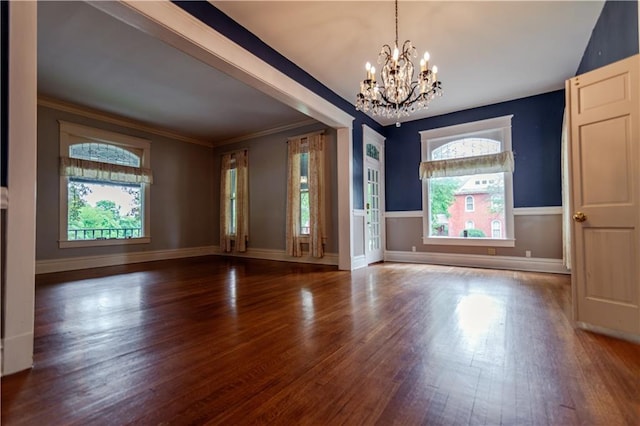 603 N 5th St, Atchison, KS 66002 - spare room featuring a chandelier, wood finished floors, healthy amount of natural light, crown molding, and baseboards