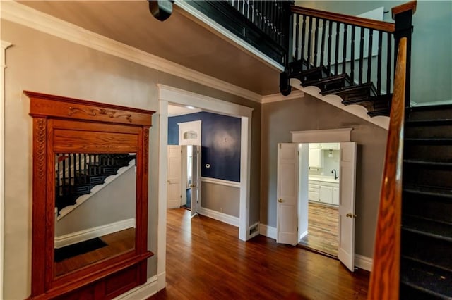 603 N 5th St, Atchison, KS 66002 - stairs with ornamental molding, wood finished floors, and baseboards
