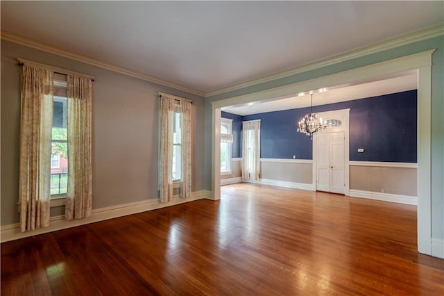 603 N 5th St, Atchison, KS 66002 - unfurnished room with a chandelier, wood finished floors, crown molding, and baseboards