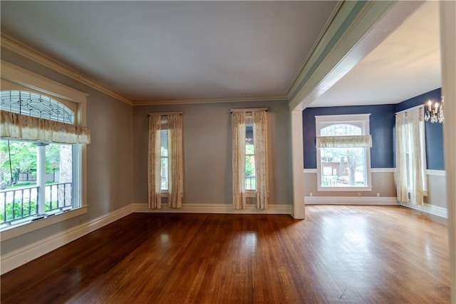 603 N 5th St, Atchison, KS 66002 - spare room featuring hardwood / wood-style flooring, plenty of natural light, a chandelier, baseboards, and crown molding