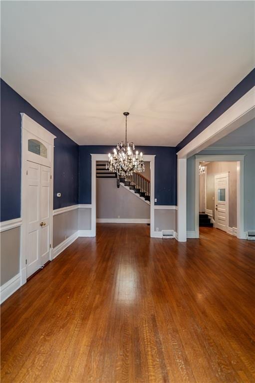 603 N 5th St, Atchison, KS 66002 - unfurnished dining area with a chandelier, wood finished floors, a baseboard heating unit, and baseboards