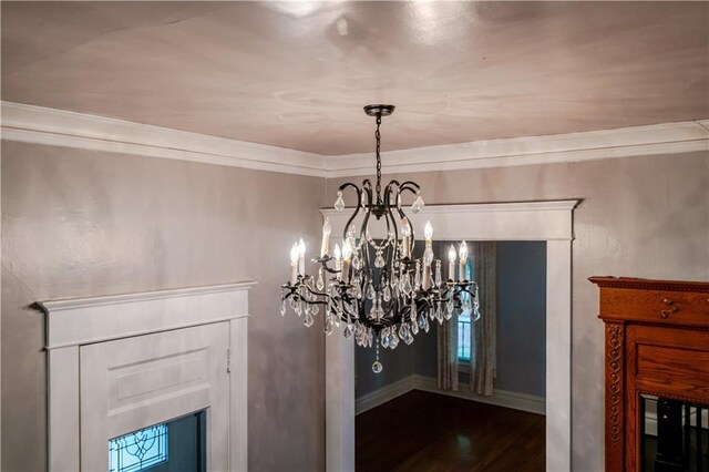 603 N 5th St, Atchison, KS 66002 - detailed view of a chandelier, wood finished floors, crown molding, a fireplace, and baseboards