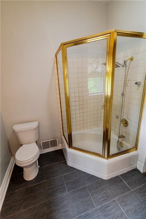 603 N 5th St, Atchison, KS 66002 - full bathroom with toilet, enclosed tub / shower combo, baseboards, and tile patterned flooring