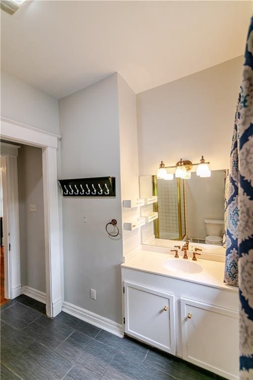 603 N 5th St, Atchison, KS 66002 - full bath featuring vanity, baseboards, toilet, and tile patterned flooring