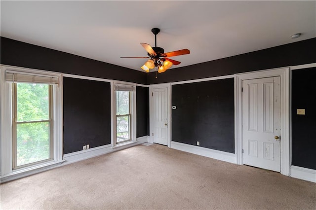 603 N 5th St, Atchison, KS 66002 - unfurnished bedroom featuring carpet flooring, baseboards, and a ceiling fan