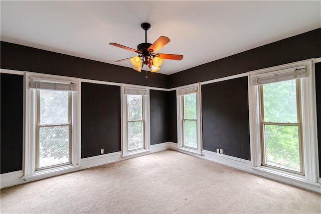 603 N 5th St, Atchison, KS 66002 - carpeted empty room with healthy amount of natural light, a ceiling fan, and baseboards